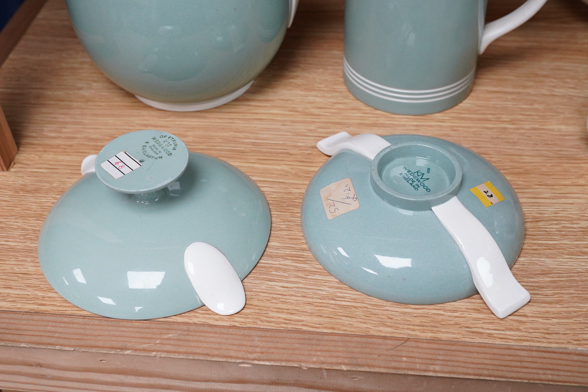 Keith Murray for Wedgwood - a celadon mug, two handled vase and two tazzas, tallest 13cm